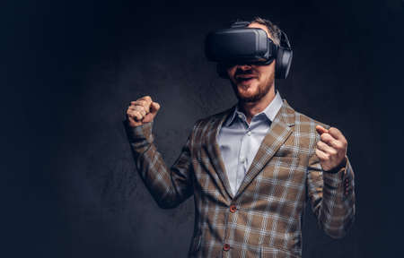 Studio portrait of a man wearing virtual reality glasses on a da