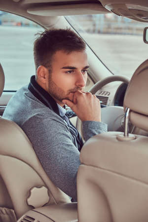 A handsome businessman in luxury car