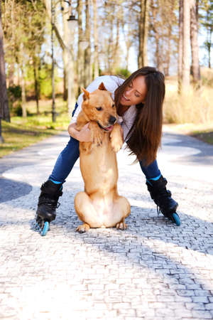 Outdoors lifestyle portrait of a beautiful girl wearing roller sの写真素材