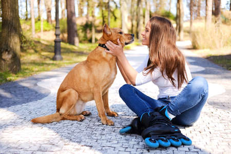 Outdoors lifestyle portrait of a beautiful girl wearing roller skateの写真素材