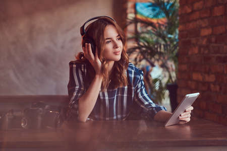 A young charming sensual girl listening to a music in headphonesの写真素材
