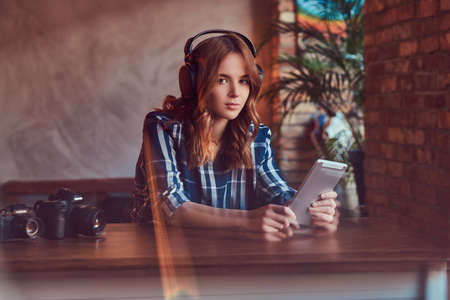 A young charming sensual girl listening to a music in headphonesの写真素材