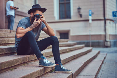 A handsome hipster male with a stylish beard and tattoo on his armの写真素材