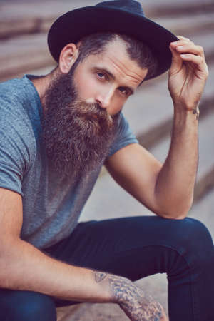 A handsome hipster male with a stylish beard with a tattoo on hiの写真素材