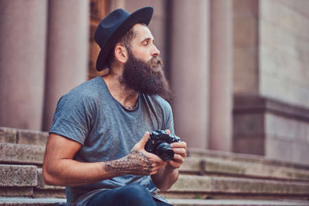 A handsome hipster male with a stylish beard with a tattoo on his armの写真素材