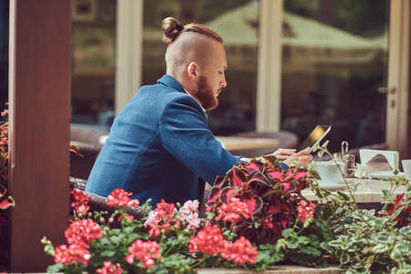 A handsome redhead businessman with a stylish haircut and beardの写真素材