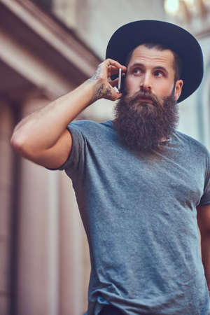 A handsome hipster male with a stylish beard and a tattoo on his armの写真素材
