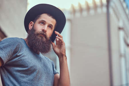 A handsome hipster male with a stylish beard and a tattoo on his armの写真素材