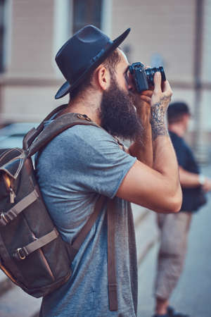 A handsome hipster male with a stylish beard and a tattoo on his armの写真素材