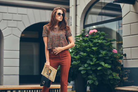 Beautiful fashionable brunette in a trendy clothing and sunglassesの写真素材