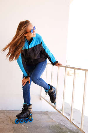 Happy joyful young woman in sportswear and sunglassesの写真素材