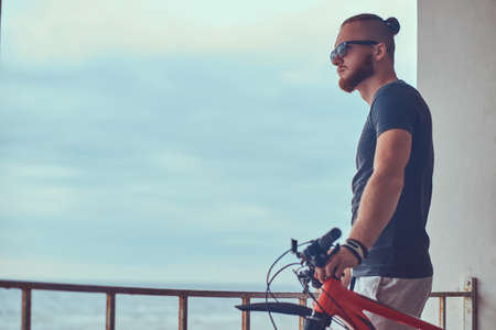 A handsome redhead male with a stylish haircut and beard dressedの写真素材