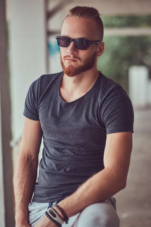 A handsome redhead male with a stylish haircut and beard dressedの写真素材