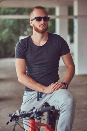 A handsome redhead male with a stylish haircut and beard dressedの写真素材