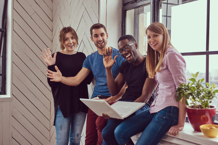 Group of multiracial students working with a laptop.