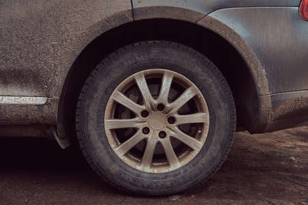 Close-up image of a dirty car after a trip around the countryside