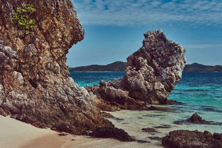 Beautiful landscape rocky stalactite reefs on the shore of Philippine Islands.
