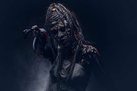 Close-up portrait of a witch from the indigenous African tribe, wearing traditional costume. Make-up concept.の写真素材