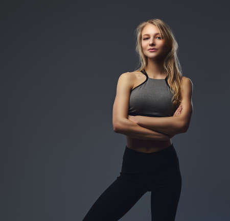 Sexy slim blonde girl in a sportswear posing in a studio.の写真素材