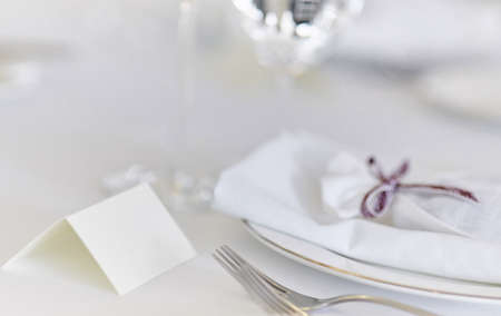 Ornate table, name card with purple ribbon and place for your text.の写真素材
