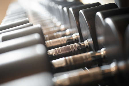 Closeup image of dumbells on a stand. Gym equipmentの写真素材