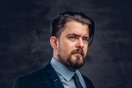 Close-up portrait of a handsome middle-aged man with beard and hairstyle dressed in an elegant...