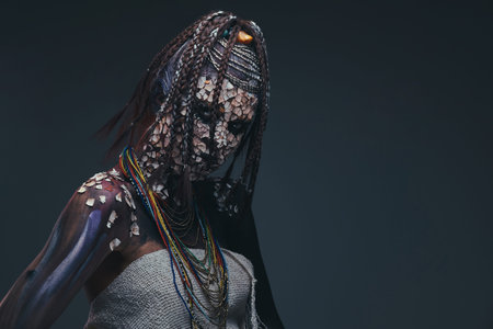 Portrait of a scary African shaman female with a petrified cracked skin and dreadlocks. Make-up...