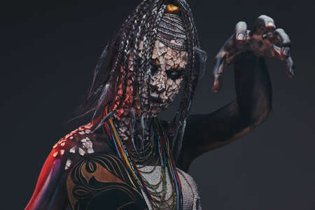 Scary African shaman with a petrified cracked skin and dreadlocks. Make-up concept.の写真素材