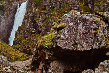 Waterfall in rocky mountains. Amazing nature in Norway.