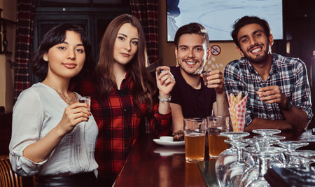 Young multiracial friends resting in the pub.