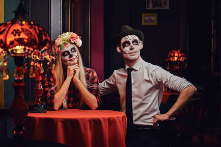 Young attractive couple with undead makeup during dating at a mexican restaurant.の写真素材