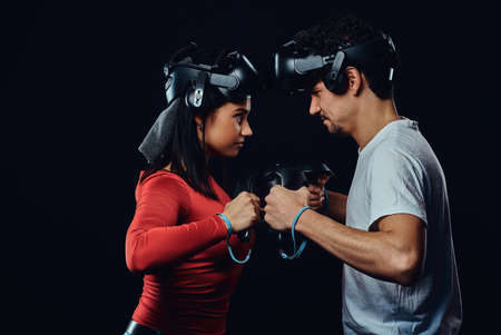 oncept of competition and confrontation. Couple of pro gamers with VR headsets participate in the game battle.の写真素材