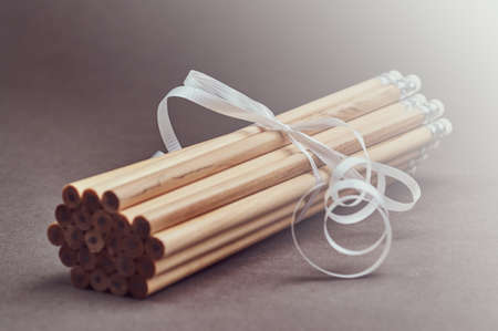 Set of pencils decorated with a white gift ribbon.の写真素材