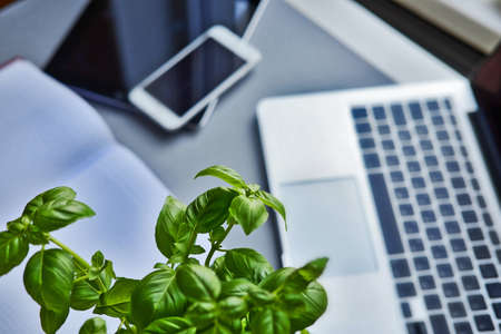 Open laptop, tablet, smartphone and notebook on a table in the office