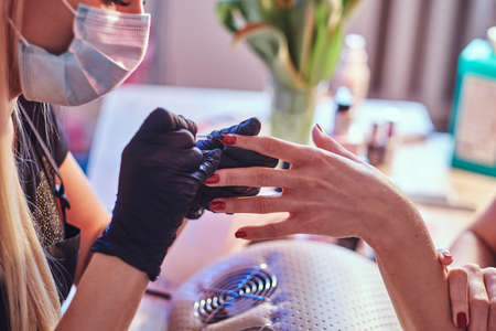 Closeup hands. Nail care and manicure. Woman in a beauty salonの写真素材