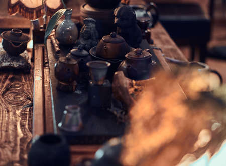 Traditional Asian tea ceremony. Set of accessories, ceramic cups and teapots, dry herbal leaves, all for making a natural delicious aromatic teaの写真素材
