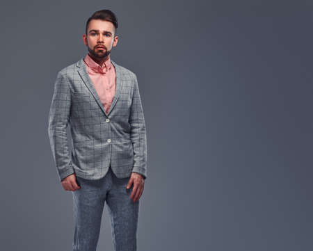 Portrait of styilish serious man in checkered blazer and pink shirt.の写真素材