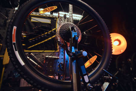 Closeup photoshoot of bicycle wheel at trendy workshop.