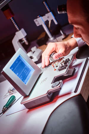 Mature watchmaker is working with WITSCHI ANALYZER Q1 at his own studio.