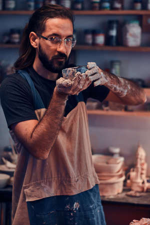 Portrait of hardworking man with clay at his own studio.の写真素材