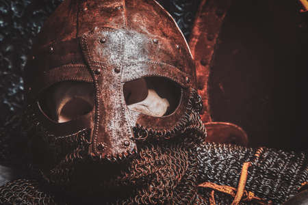 Ols rusted ancient helmet with human skull inside.の写真素材