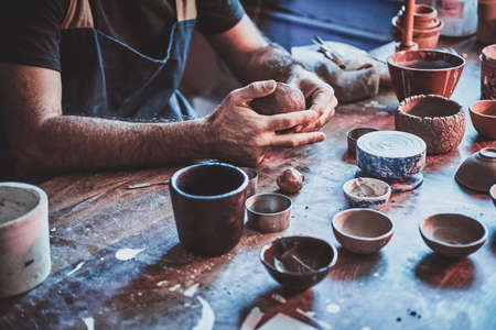Closeup photoshoot of working process with clay by diligent man.の写真素材