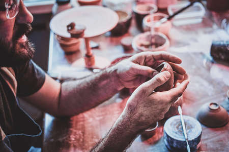 Closeup photoshoot of working process with clay by diligent man.の写真素材