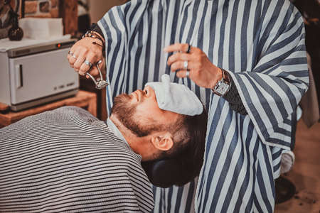 Bearded client just got good beardcare from talanted trendy barber.の写真素材