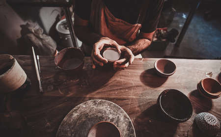 Closeup photoshoot of working process with clay by diligent man.の写真素材