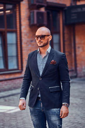 Young sucessful businesman is posing for photographer near his office.の写真素材