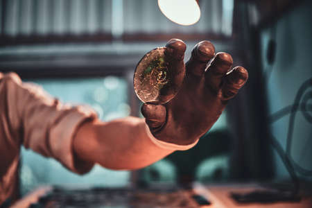Closeup photo shoot of mans hand holding peace of restorer glass.の写真素材