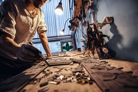 Diligent craftman is restoring ancient broken stained glass at his own workshop.の写真素材