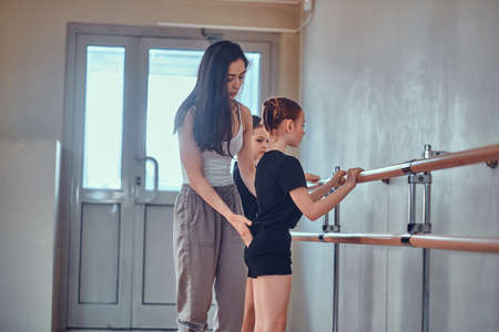 Daily rehearsal of young diligent ballerinas at gymnastic school with expirienced teacher.の写真素材