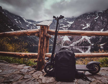Touristic view point with amaizing view of mountains and lake with mirroed reflection. Trere are scooter at the front.の写真素材